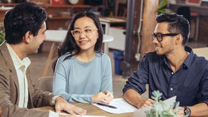 three people at a meeting three people at a meeting