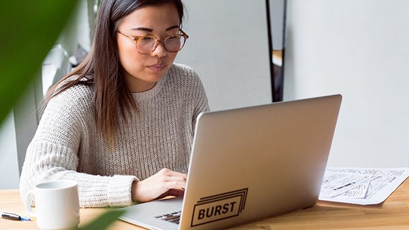 employee on laptop with headphones employee on laptop with headphones accessing Robert Walters Outplacement Services Career Toolkit
