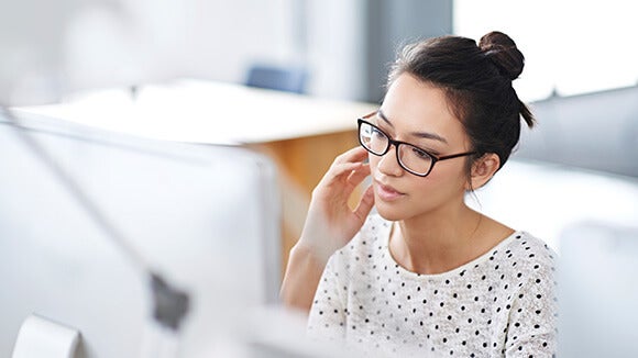 bespectacled woman bespectacled woman with hair bun in a white room