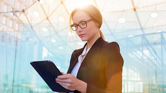 woman-in-suit-on-ipad woman-in-suit-on-ipad