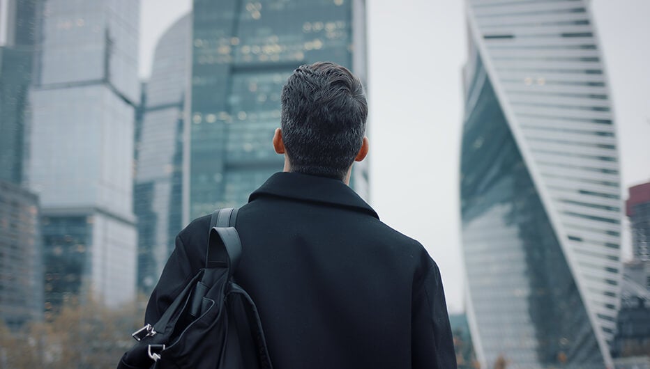 man looking at buildings