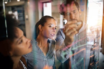 Programmers working cooperating at IT company developing apps