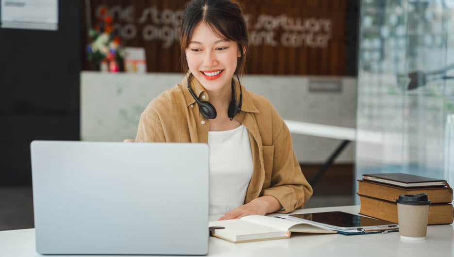Asian businesswoman working on laptop computer Look for job online, freelance looking and typing on notebook on table, lifestyle of woman studying online