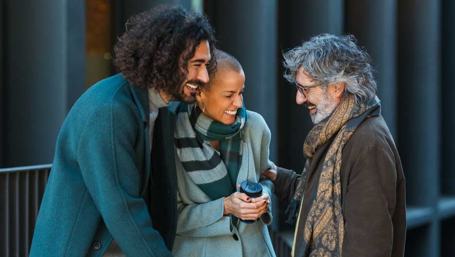 Business people having fun and laughing while talking outdoors o